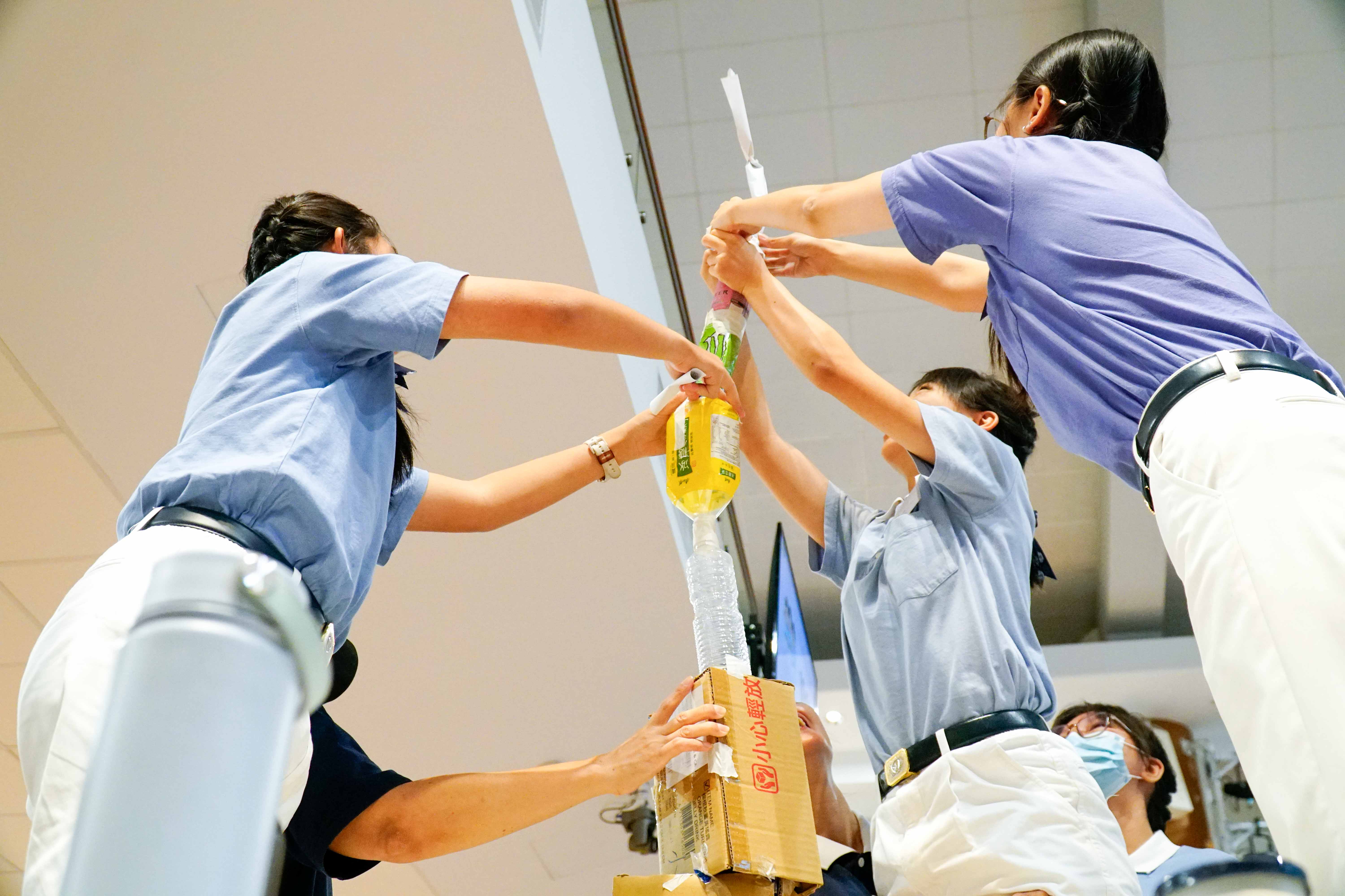 慈少在“克己”游戏项目中，利用环保素材搭建高塔，在合作中学习沟通与团队精神。摄/ 郑炳荣  